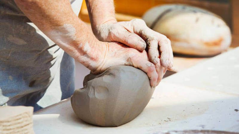 image of a person wedging clay